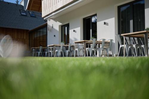 a group of tables and chairs outside of a building at Triangel Boutique Hotel in Kranjska Gora