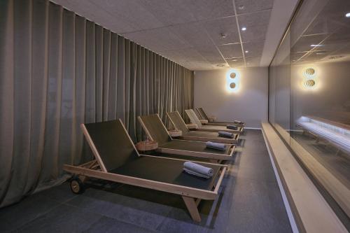 a row of chairs lined up in a room at Triangel Boutique Hotel in Kranjska Gora