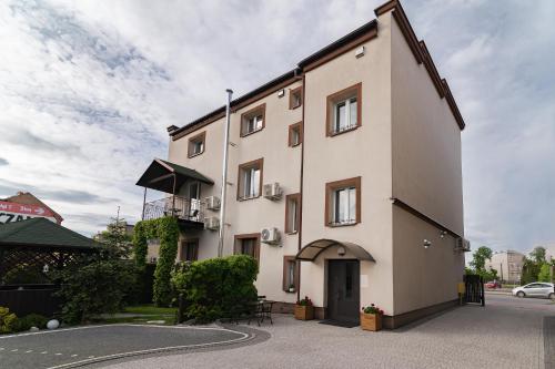 a white building with a black roof at Astra Apartments in Oświęcim