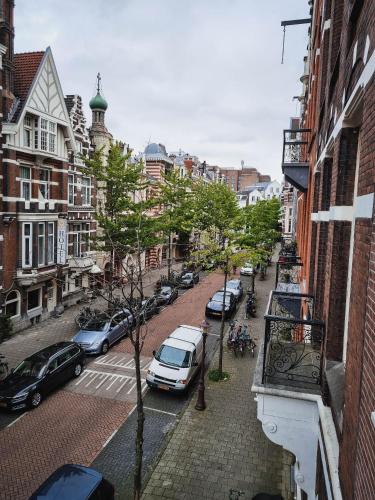 a city street with cars parked on the street at Hotel Vondel Garden in Amsterdam