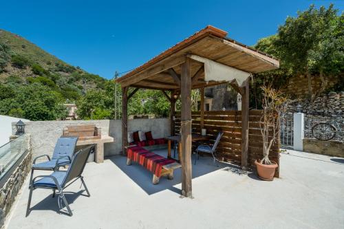 a gazebo with a table and chairs on a patio at Dream House in Perivólia