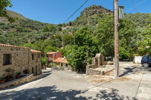 an empty street in a village with a mountain at Dream House in Perivólia