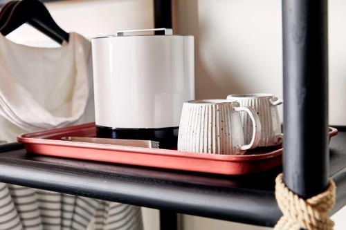 a tray with two coffee cups on a shelf at El Capitan Hotel in Merced