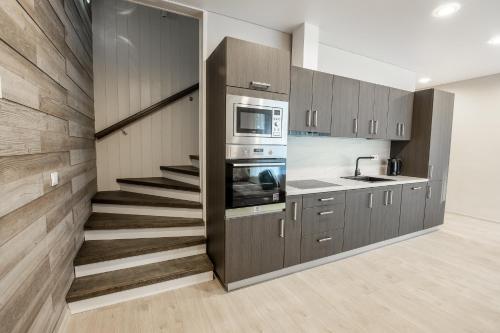 a kitchen with a staircase leading up to a stair case at Villa MARIKA plus in Alajõe