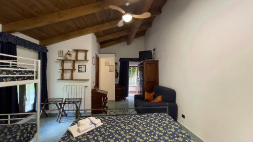 a bedroom with a bed and a living room at Agriturismo La Casa Del Ghiro in Pimonte