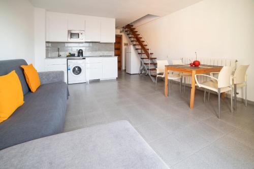 a living room with a couch and a dining room table at Apartaments Atzavara in Calella