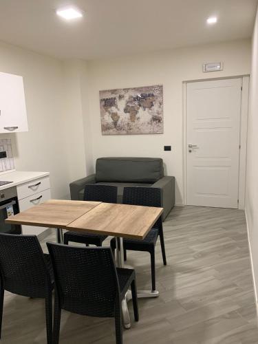 a room with a table and chairs and a couch at Pigneto Square Home in Rome