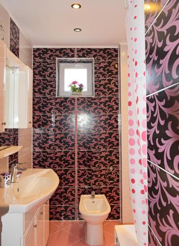 a bathroom with a toilet and a sink at dream apartment in Obzor