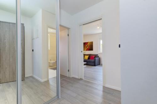 a room with a mirror and a living room at Apartments Hemetek in Veli Lošinj