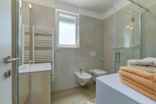 a bathroom with a toilet and a sink and a shower at Apartments Hemetek in Veli Lošinj