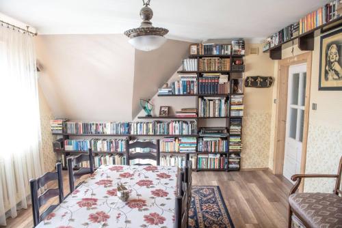 a dining room with book shelves filled with books at Noclegi u Ewy in Witów