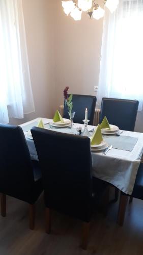 a dining room table with a white table cloth and chairs at Ferienhaus Inge in Kirchberg an der Raab