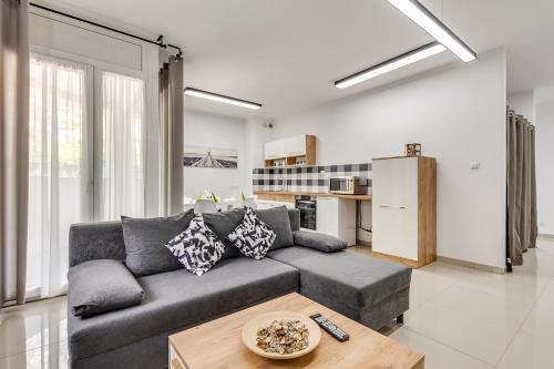 a living room with a couch and a table at Green Apartments Katowice Chorzów in Chorzów