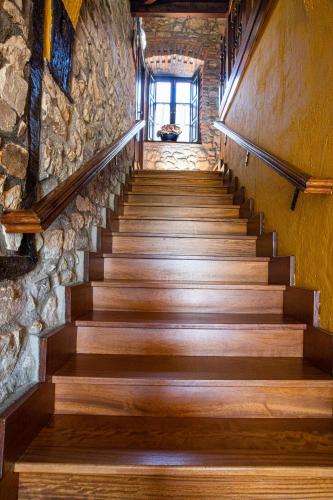 a staircase in a building with a stone wall at La Casona de Tresgrandas in Tresgrandas