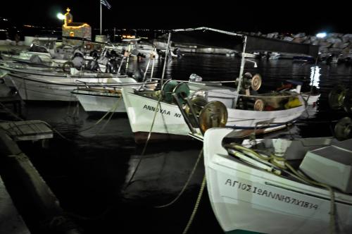 a group of boats docked in a harbor at night at Villas Kalives in Kalyves
