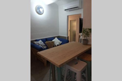 a living room with a wooden table and a couch at M2 Cool apartment next to metro. 15m to center in Esplugues de Llobregat