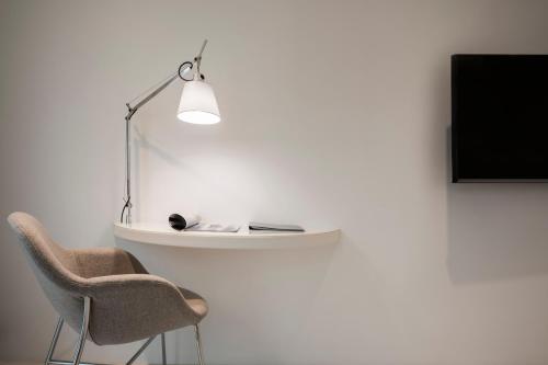 a chair and a lamp next to a wall at RIVALMARE Beach Boutique Hotel - NEW! in Novigrad Istria