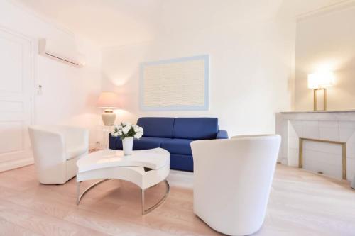 - un salon avec un canapé bleu et des fauteuils blancs dans l'établissement 2-Br City center near Croisette & Palais, à Cannes