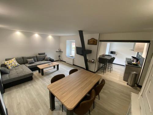 a living room with a couch and a table at Residence Gaby & Tom 4 Étoiles in Contrexéville
