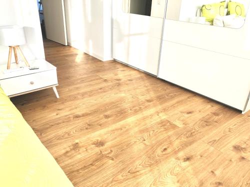 a kitchen with wooden floors and a white refrigerator at Panorama Penthouse Apartment mit Klima und Whirlpool für bis zu 6 Personen in Frankenthal
