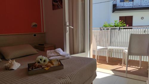 a hotel room with a tray of food on a bed at Hotel Eliani in Grado