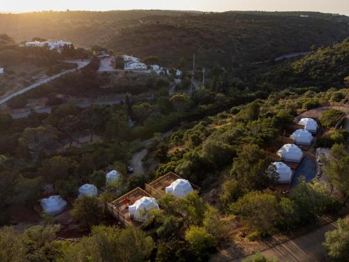 an overhead view of a group of tents in a forest at Salema Eco Camp - Sustainable Camping & Glamping in Salema