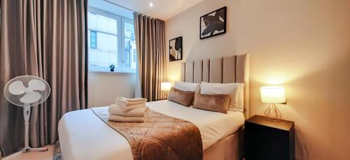 ロンドンにあるOne Bed Serviced Apt near Holborn in Chancery Laneのベッドと窓が備わるホテルルーム