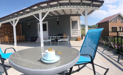 a patio with a table with a hat on it at COTTAGE CHALET and TOURS in Dilijan