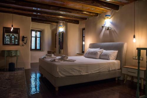 a bedroom with a large bed in a room at Odos Oneiron Boutique Hotel in Chania