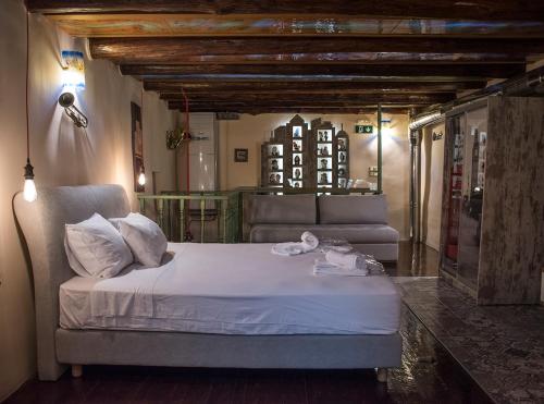 a bedroom with a bed and a couch in a room at Odos Oneiron Boutique Hotel in Chania