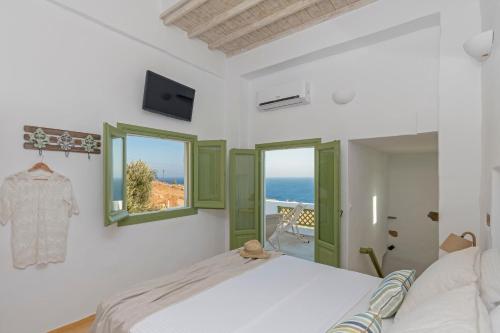 a bedroom with a bed and a view of the ocean at Elia Traditional suites in Astypalaia