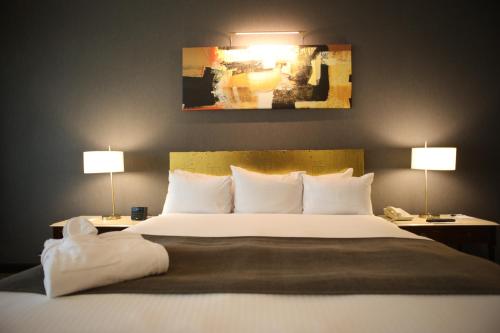 a bedroom with a large bed with two lamps at Radisson Montevideo Victoria Plaza Hotel in Montevideo
