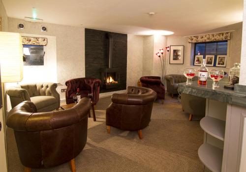a living room with couches and chairs and a fireplace at Elder Grove in Ambleside