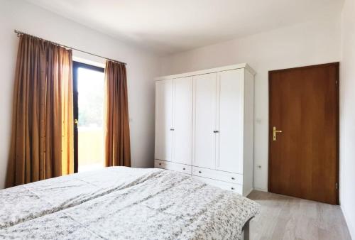 a bedroom with a bed and a large window at Casa Sol Maris in Novigrad Istria