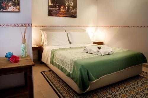 a bedroom with a bed with towels on it at Le Viùzze Apartment in Tricase