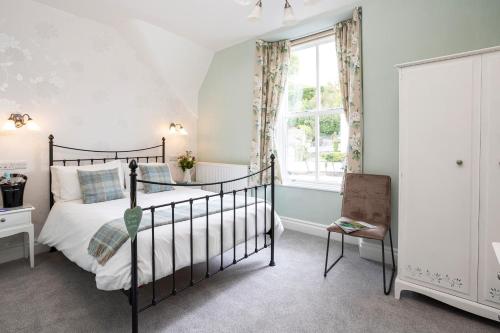 a bedroom with a bed and a window at Elder Grove in Ambleside