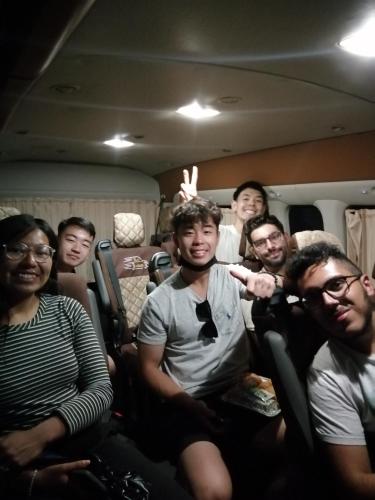 a group of people sitting in a van at david hostel in Aswan