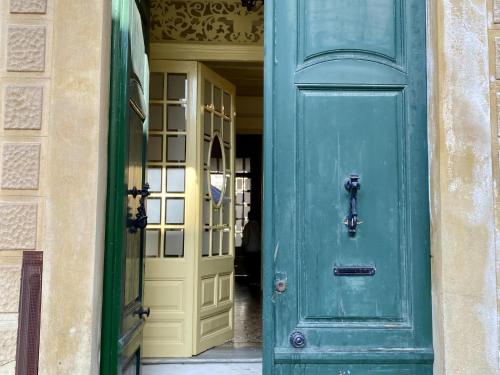 a green door in a building with a yellow door at El masnou in Masnou
