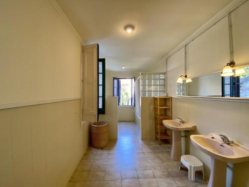a bathroom with two sinks and two mirrors at El masnou in Masnou