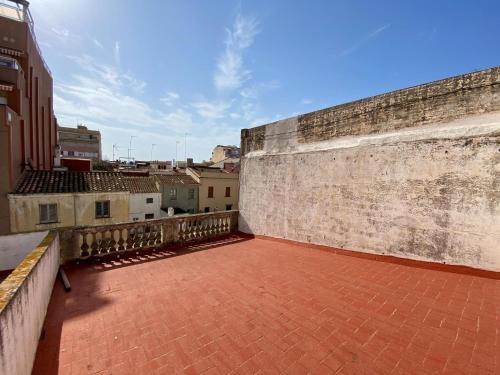 a balcony with a brick floor and a wall at El masnou in Masnou