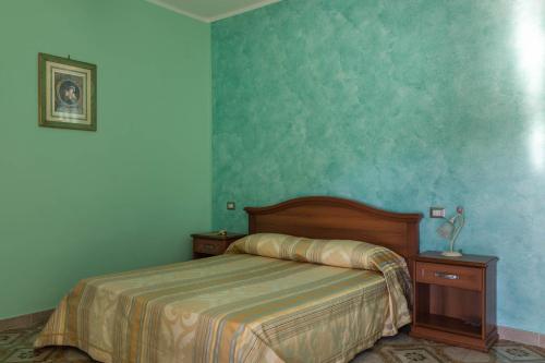 a bedroom with a bed and blue walls at B&B La Mortella in Albanella