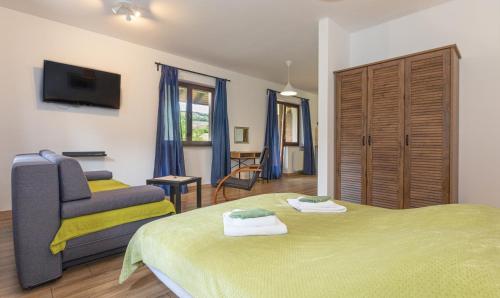 a bedroom with a green bed and a chair at B&B Green Serenity Plitvice Lakes in Plitvička Jezera