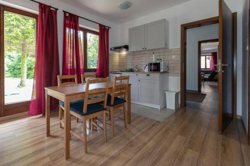 a kitchen and dining room with a table and chairs at B&B Green Serenity Plitvice Lakes in Plitvička Jezera