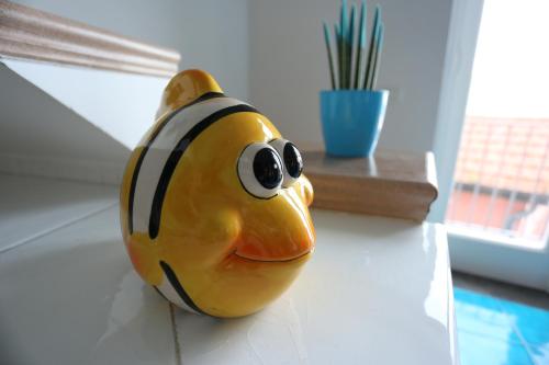 um brinquedo de peixe amarelo e preto sentado numa mesa em Casa Gilda em Sorrento