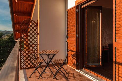 a chair on the balcony of a house at B&B La Mortella in Albanella