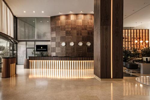a lobby with clocks on the wall in a building at InterContinental Malta by IHG in St Julian's