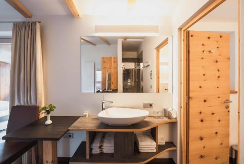 a bathroom with a sink and a mirror at Hotel Bischofhof in Chiusa
