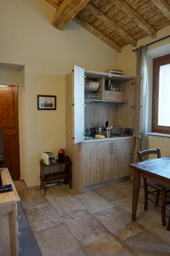 a kitchen with a counter and a table in a room at Agriturismo Cheloni in Guasticce