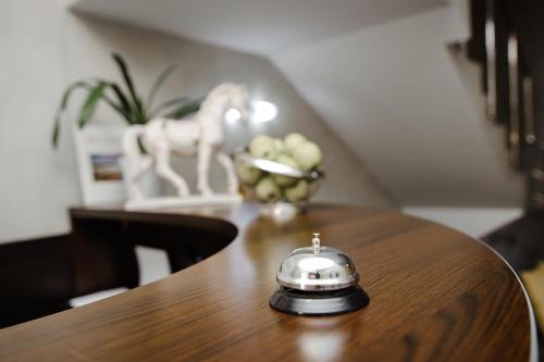 a tea kettle sitting on top of a wooden table at TipTop Hotel CITY CENTER in Chişinău