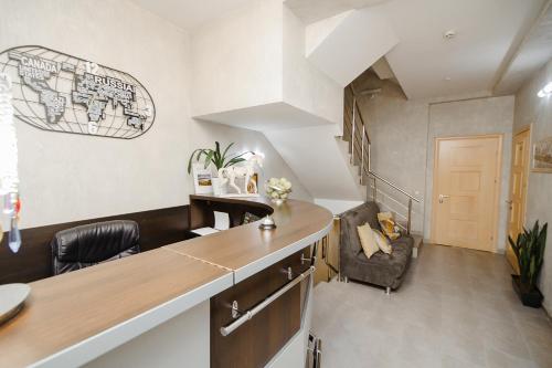 a kitchen with a counter and a living room at TipTop Hotel CITY CENTER in Chişinău